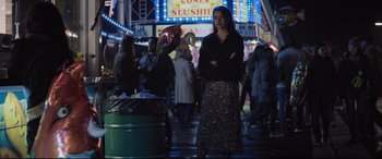 Movie still from “Death Note” (2017), directed by Adam Wingard – A woman standing next to a trash can on a sidewalk; Medium shot, Over the shoulder angle
