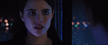 Movie still from “Death Note” (2017), directed by Adam Wingard – A young woman with blue eyes stares at the camera; Close Up shot, Low angle