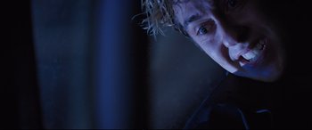 Movie still from “Death Note” (2017), directed by Adam Wingard – A man's face in the dark; Close Up shot, Low angle