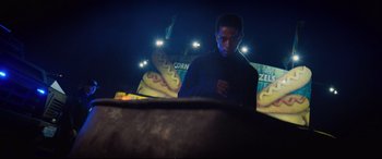 Movie still from “Death Note” (2017), directed by Adam Wingard – A man standing in front of a fire pit at night; Medium shot, Low angle