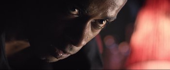 Movie still from “Death Note” (2017), directed by Adam Wingard – A man's face in the dark; Extreme Close Up shot, Low angle