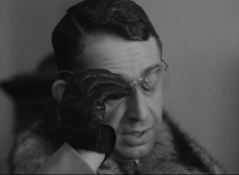 Movie still from “Closely Watched Trains” (1966), directed by Jirí Menzel – An old man wearing glasses and a fur coat; Close Up shot, Low angle