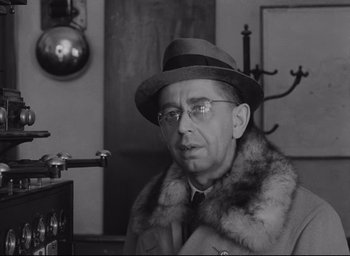 Movie still from “Closely Watched Trains” (1966), directed by Jirí Menzel – An older man wearing a fur coat and a hat; Close Up shot, Low angle