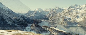 Movie still from “Clouds of Sils Maria” (2014), directed by Olivier Assayas – A view of a lake and mountains in the distance; Extreme Wide shot, High angle