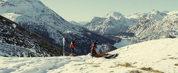 Movie still from “Clouds of Sils Maria” (2014), directed by Olivier Assayas – Two people standing on top of a snow covered slope; Extreme Wide shot, Low angle