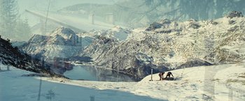 Movie still from “Clouds of Sils Maria” (2014), directed by Olivier Assayas – Two people are standing on a snowy hill; Extreme Wide shot, High angle