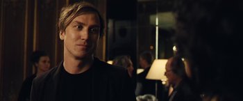 Movie still from “Clouds of Sils Maria” (2014), directed by Olivier Assayas – A person wearing a jacket; Close Up shot, Over the shoulder angle