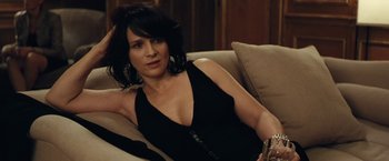 Movie still from “Clouds of Sils Maria” (2014), directed by Olivier Assayas – A woman sitting on top of a couch in a room; Close Up shot, High angle