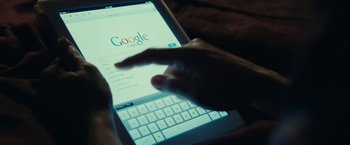 Movie still from “Clouds of Sils Maria” (2014), directed by Olivier Assayas – A person using a tablet computer on a bed; Extreme Close Up shot, Overhead angle