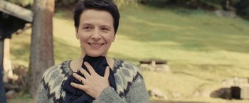 Movie still from “Clouds of Sils Maria” (2014), directed by Olivier Assayas – A woman with short black hair wearing a sweater; Close Up shot, Over the shoulder angle
