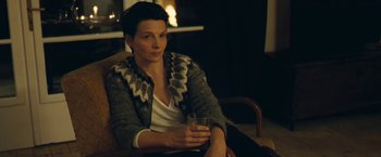 Movie still from “Clouds of Sils Maria” (2014), directed by Olivier Assayas – A woman sitting in a chair holding a glass; Medium shot, High angle
