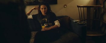 Movie still from “Clouds of Sils Maria” (2014), directed by Olivier Assayas – A woman sitting on top of a black couch; Medium shot, High angle