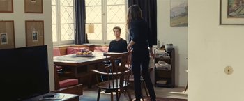 Movie still from “Clouds of Sils Maria” (2014), directed by Olivier Assayas – Two people sitting at a dining room table; Wide shot, Over the shoulder angle