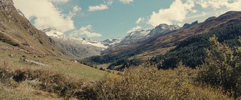 Movie still from “Clouds of Sils Maria” (2014), directed by Olivier Assayas – A view of a mountain range with snow on the top; Extreme Wide shot, High angle