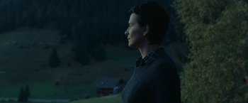 Movie still from “Clouds of Sils Maria” (2014), directed by Olivier Assayas – A woman standing in a field at night looking off into the distance; Medium shot, Low angle