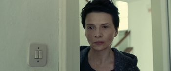 Movie still from “Clouds of Sils Maria” (2014), directed by Olivier Assayas – A person with short black hair; Close Up shot, Low angle