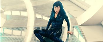 Movie still from “Clouds of Sils Maria” (2014), directed by Olivier Assayas – A woman sitting on the ground wearing a black outfit; Medium shot, Overhead angle