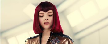 Movie still from “Clouds of Sils Maria” (2014), directed by Olivier Assayas – A woman with red hair is looking to her left; Close Up shot, Low angle