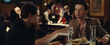 Movie still from “Clouds of Sils Maria” (2014), directed by Olivier Assayas – Two women sitting at a table in a restaurant; Medium shot, Over the shoulder angle