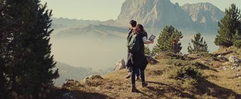 Movie still from “Clouds of Sils Maria” (2014), directed by Olivier Assayas – A man and a woman standing on top of a hill; Wide shot, High angle