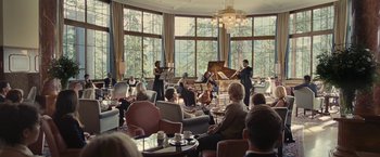 Movie still from “Clouds of Sils Maria” (2014), directed by Olivier Assayas – A group of people sitting in a room with chairs; Wide shot, Over the shoulder angle