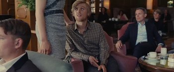 Movie still from “Clouds of Sils Maria” (2014), directed by Olivier Assayas – A man sitting on a chair in front of a crowd; Medium shot, Over the shoulder angle