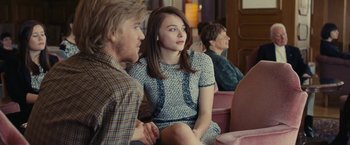 Movie still from “Clouds of Sils Maria” (2014), directed by Olivier Assayas – A man and a woman sitting on a pink couch; Medium shot, Over the shoulder angle