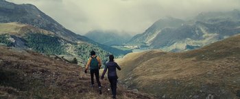 Movie still from “Clouds of Sils Maria” (2014), directed by Olivier Assayas – A couple of people that are walking up a hill; Extreme Wide shot, Low angle