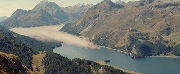Movie still from “Clouds of Sils Maria” (2014), directed by Olivier Assayas – A view of a body of water and mountains in the distance; Extreme Wide shot, High angle