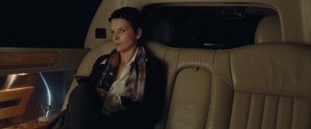 Movie still from “Clouds of Sils Maria” (2014), directed by Olivier Assayas – A woman sitting in the back seat of a car; Medium shot, High angle