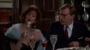 Movie still from “Clue” (1985), directed by Jonathan Lynn – A man and a woman sitting at a dinner table; Medium shot, Over the shoulder angle
