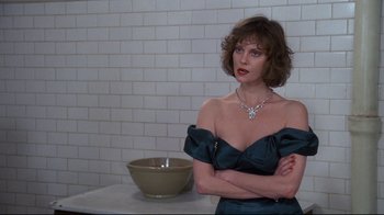 Movie still from “Clue” (1985), directed by Jonathan Lynn – A woman standing in front of a bowl in a kitchen; Close Up shot, Over the shoulder angle