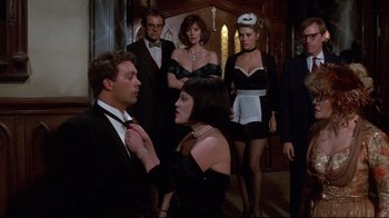 Movie still from “Clue” (1985), directed by Jonathan Lynn – A group of people dressed up for a formal event; Medium shot, Over the shoulder angle