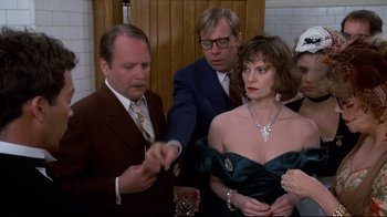 Movie still from “Clue” (1985), directed by Jonathan Lynn – A group of people standing next to each other in a room; Medium shot, Over the shoulder angle