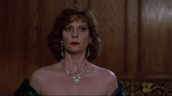 Movie still from “Clue” (1985), directed by Jonathan Lynn – A person wearing a necklace and earrings; Close Up shot, Low angle