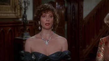 Movie still from “Clue” (1985), directed by Jonathan Lynn – A person wearing a dress and a necklace; Close Up shot, Over the shoulder angle
