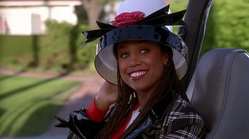Movie still from “Clueless” (1995), directed by Amy Heckerling – A young woman wearing a hat with a flower on it; Close Up shot, Over the shoulder angle