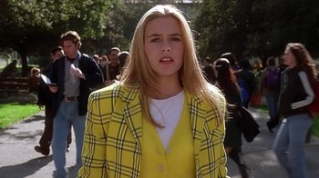 Movie still from “Clueless” (1995), directed by Amy Heckerling – A woman in a yellow jacket and a plaid jacket; Medium shot, High angle