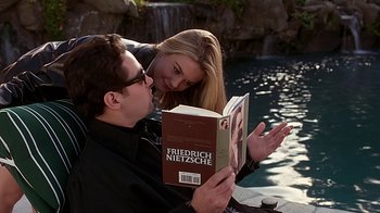 Movie still from “Clueless” (1995), directed by Amy Heckerling – A man and a woman reading a book by the water; Medium shot, Over the shoulder angle