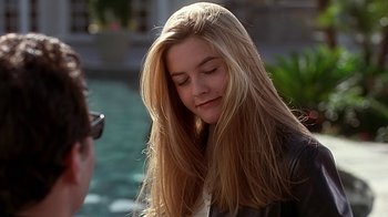 Movie still from “Clueless” (1995), directed by Amy Heckerling – A young blonde haired woman with long , straight hair; Close Up shot, Over the shoulder angle