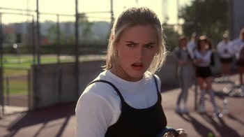 Movie still from “Clueless” (1995), directed by Amy Heckerling – A woman with a tennis racket on a tennis court; Close Up shot, Over the shoulder angle
