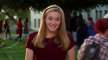 Movie still from “Clueless” (1995), directed by Amy Heckerling – A young woman with long blonde hair wearing a maroon dress; Medium shot, High angle