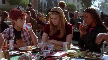 Movie still from “Clueless” (1995), directed by Amy Heckerling – A group of people sitting at a table eating food; Medium shot, High angle