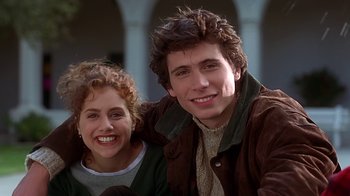 Movie still from “Clueless” (1995), directed by Amy Heckerling – A man and a woman smiling for the camera; Close Up shot, Low angle
