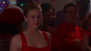 Movie still from “Clueless” (1995), directed by Amy Heckerling – A woman in a red dress in front of a group of people; Close Up shot, Over the shoulder angle