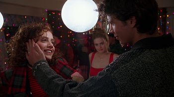 Movie still from “Clueless” (1995), directed by Amy Heckerling – A man and a woman dancing in front of a crowd; Medium shot, Over the shoulder angle