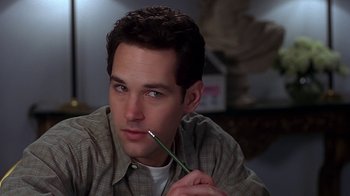 Movie still from “Clueless” (1995), directed by Amy Heckerling – A man holding a pencil in his mouth; Close Up shot, High angle