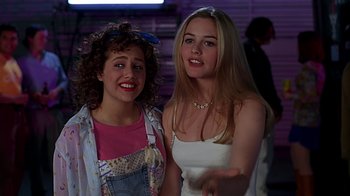 Movie still from “Clueless” (1995), directed by Amy Heckerling – Two young women standing next to each other in a room; Medium shot, Over the shoulder angle