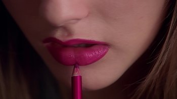 Movie still from “Clueless” (1995), directed by Amy Heckerling – A woman's lips with a pink lipstick on; Extreme Close Up shot, High angle