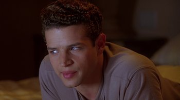 Movie still from “Clueless” (1995), directed by Amy Heckerling – A young man is looking into the distance; Close Up shot, Over the shoulder angle